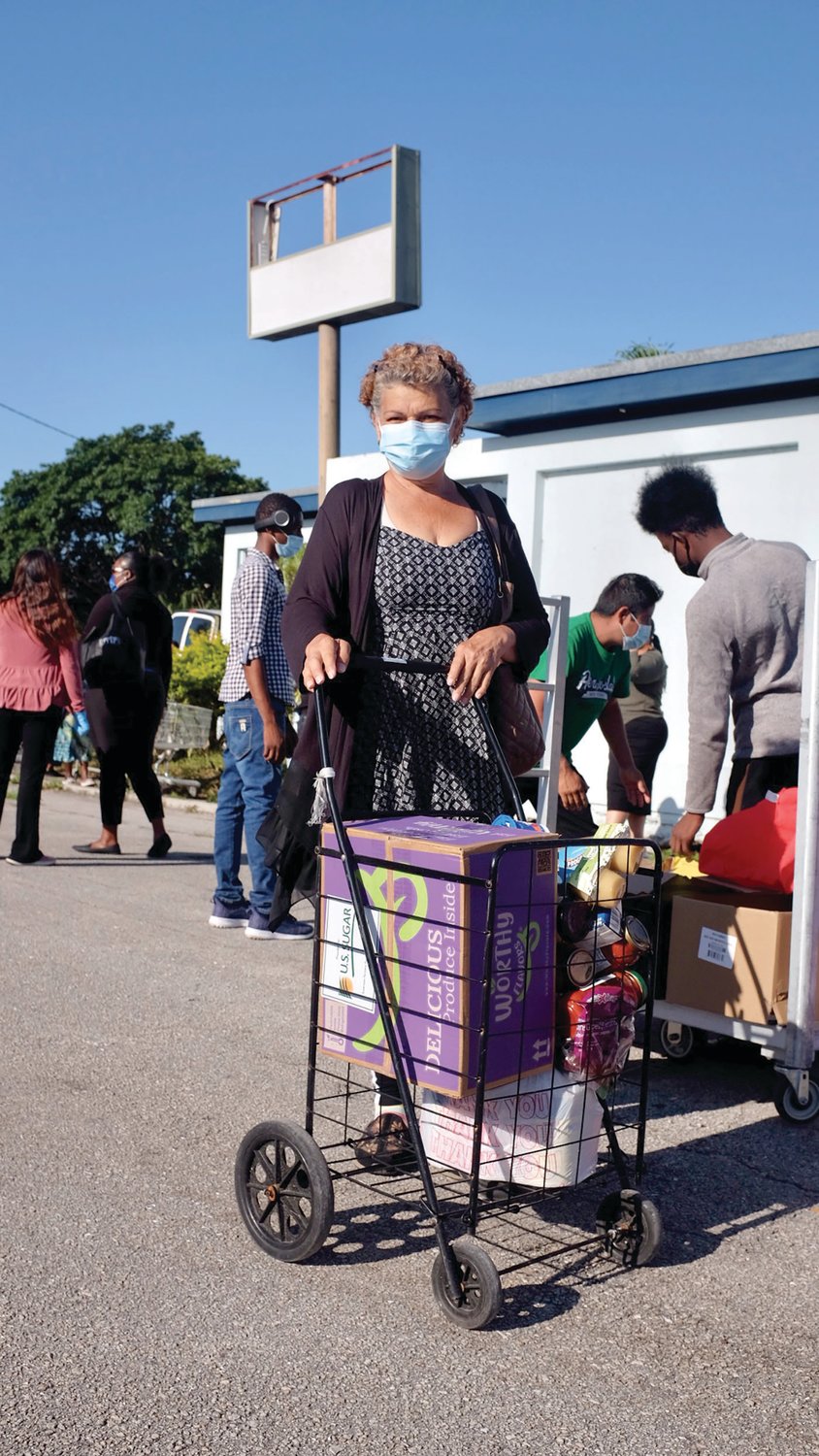 A client of The Glades Initiative, Aida Hernandez, after receiving food during this week’s food distribution.
